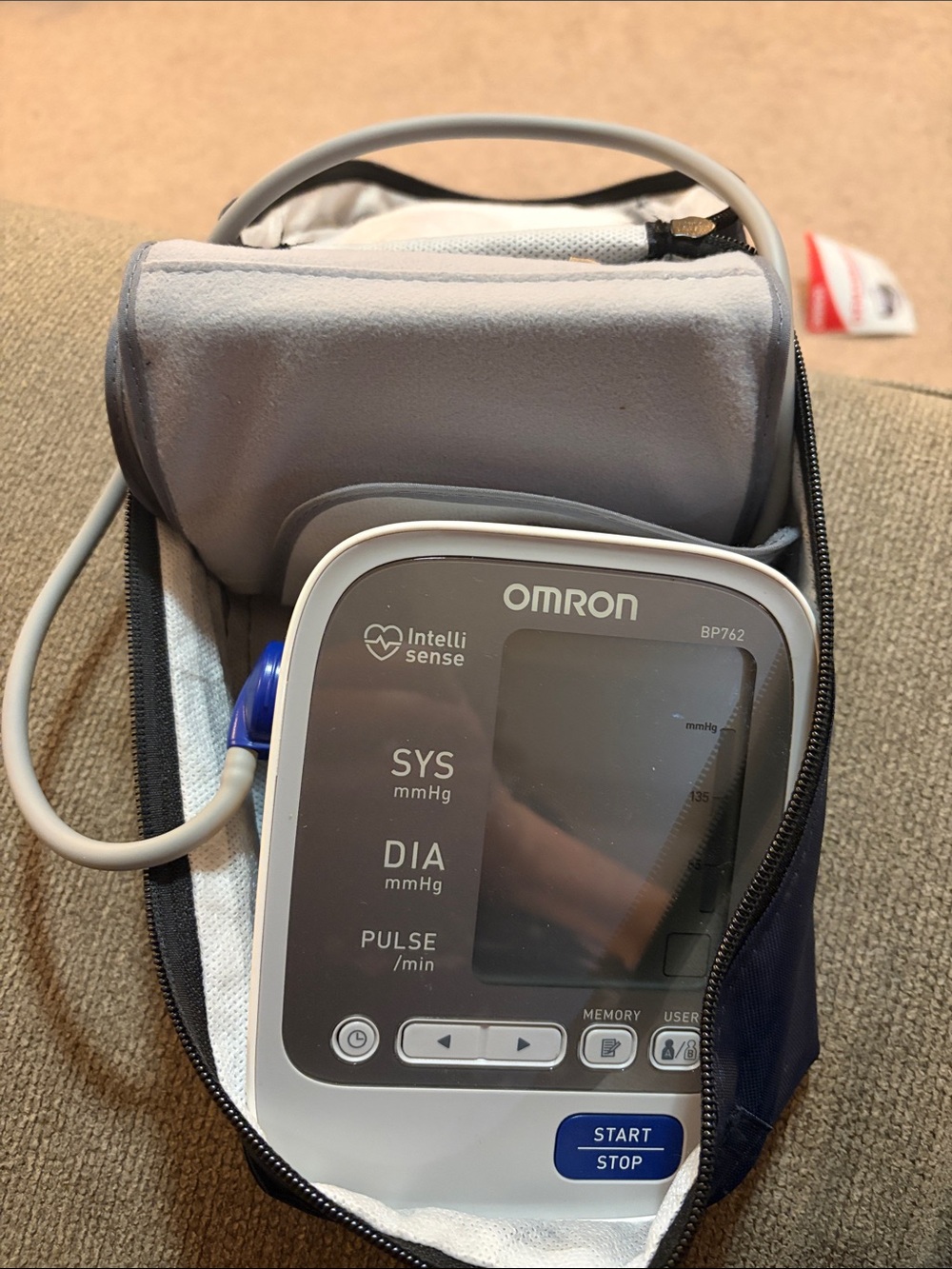 OMRON White and Gray Portable Blood Pressure Monitor with Blue Accent
